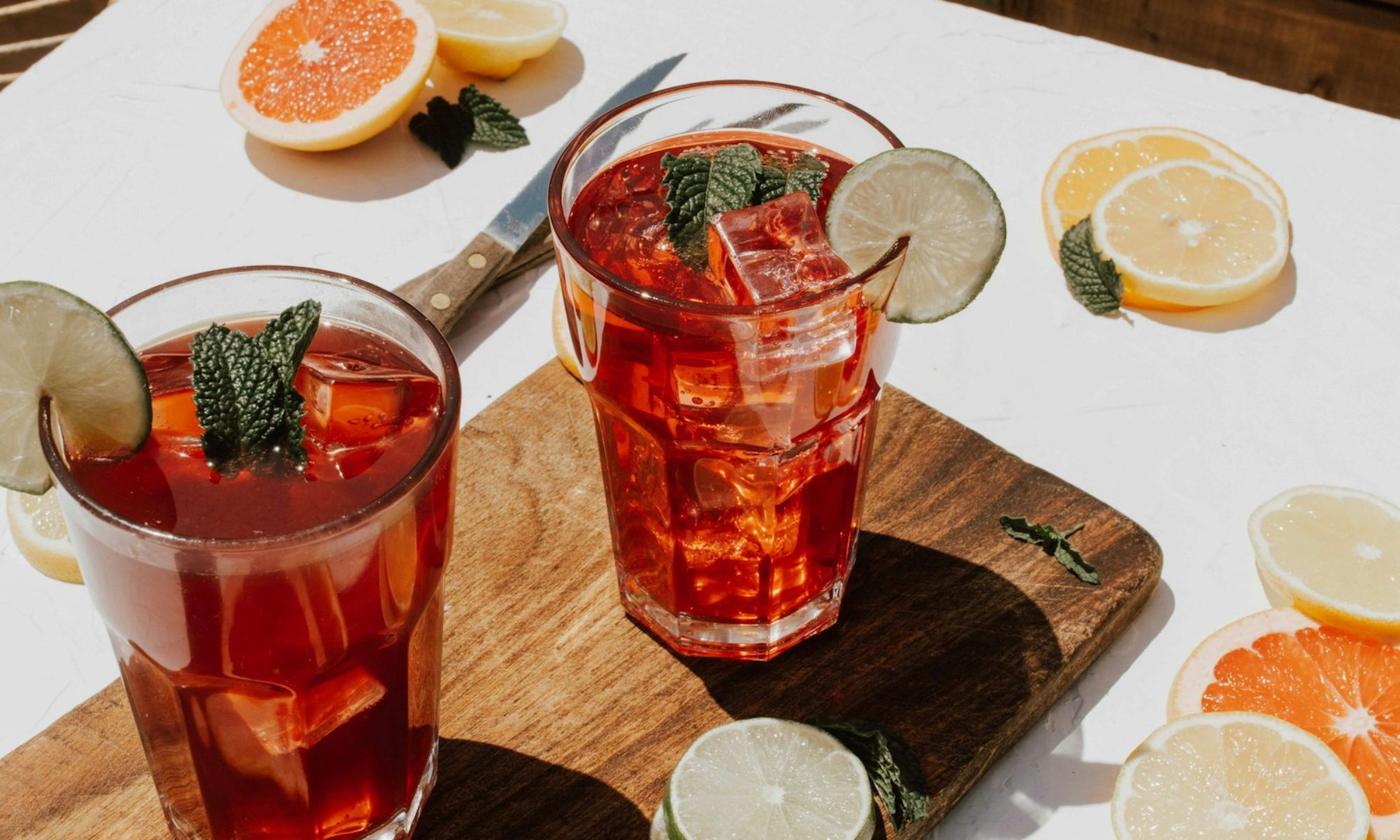 two clear drinking glasses with filled red liquid